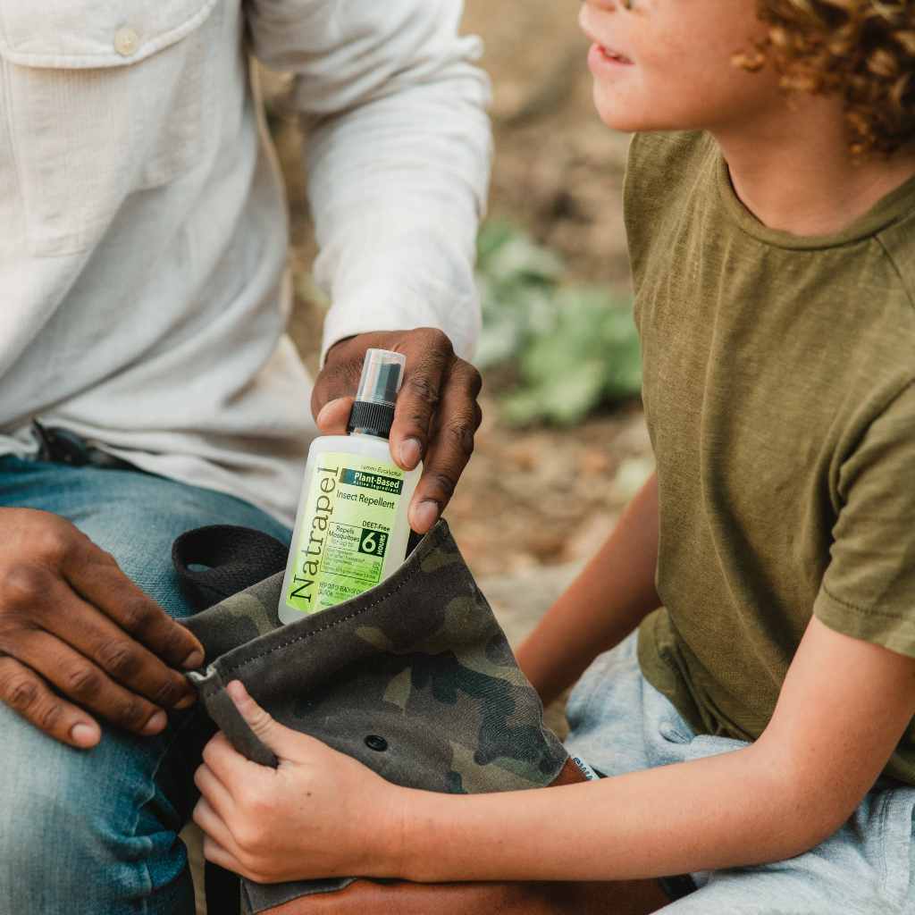 Natrapel Lemon Eucalyptus Tick & Insect Repellent 3.4 oz. Pump Spray man pulling out of camo bag in child's hands