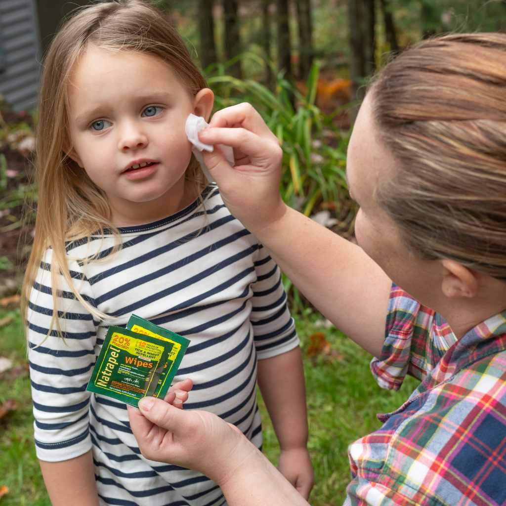 Natrapel Picaridin Tick & Insect Repellent Wipes woman using wipe on girl's face