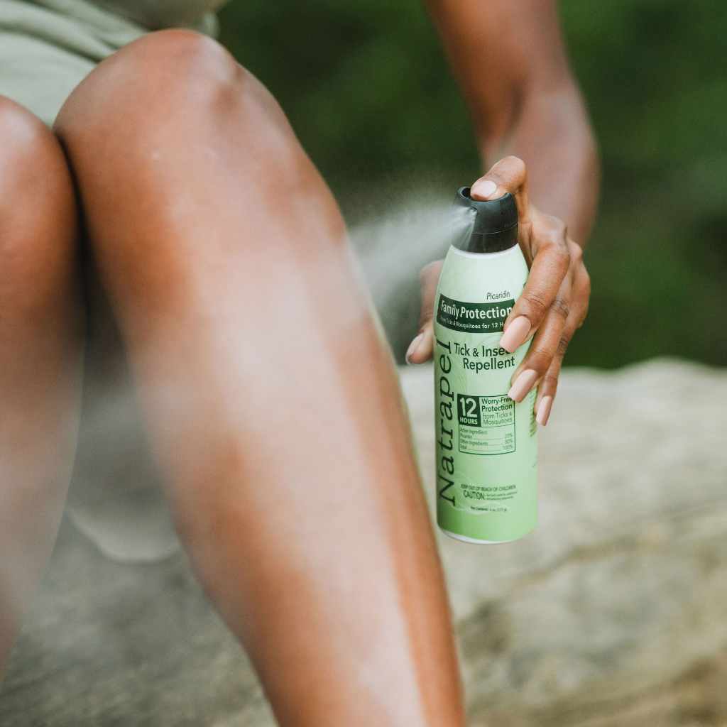Natrapel Picaridin Tick & Insect Repellent Eco-Spray 6 oz. person spraying on leg