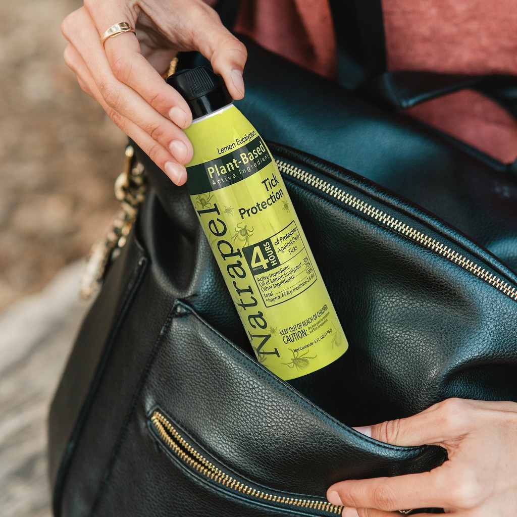 Natrapel Lemon Eucalyptus Tick Repellent Eco-Spray 6 oz. woman pulling from black purse