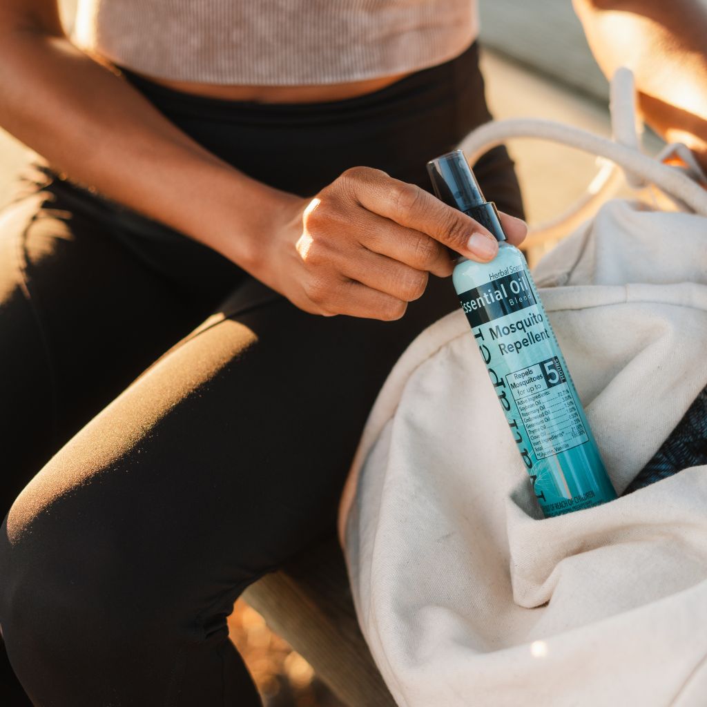 Woman taking the Natrapel Essential Oil Insect Repellent bottle out of a bag