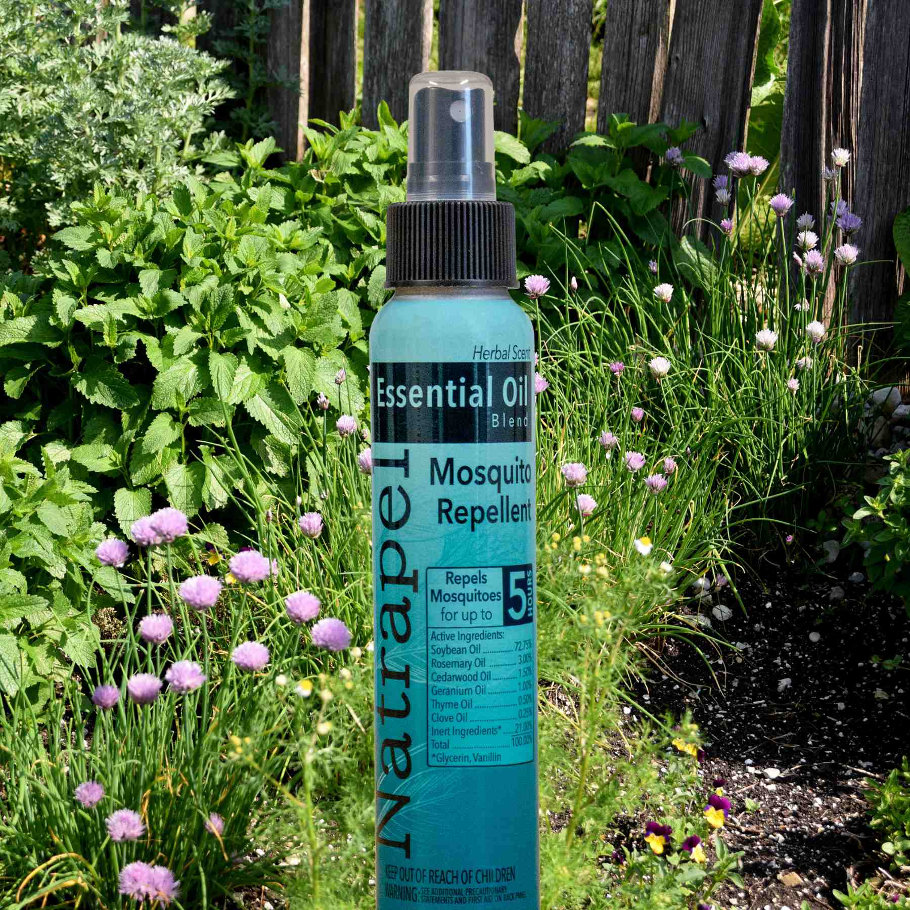 Natrapel Essential Oil Mosquito Repellent 4 oz. in front of garden