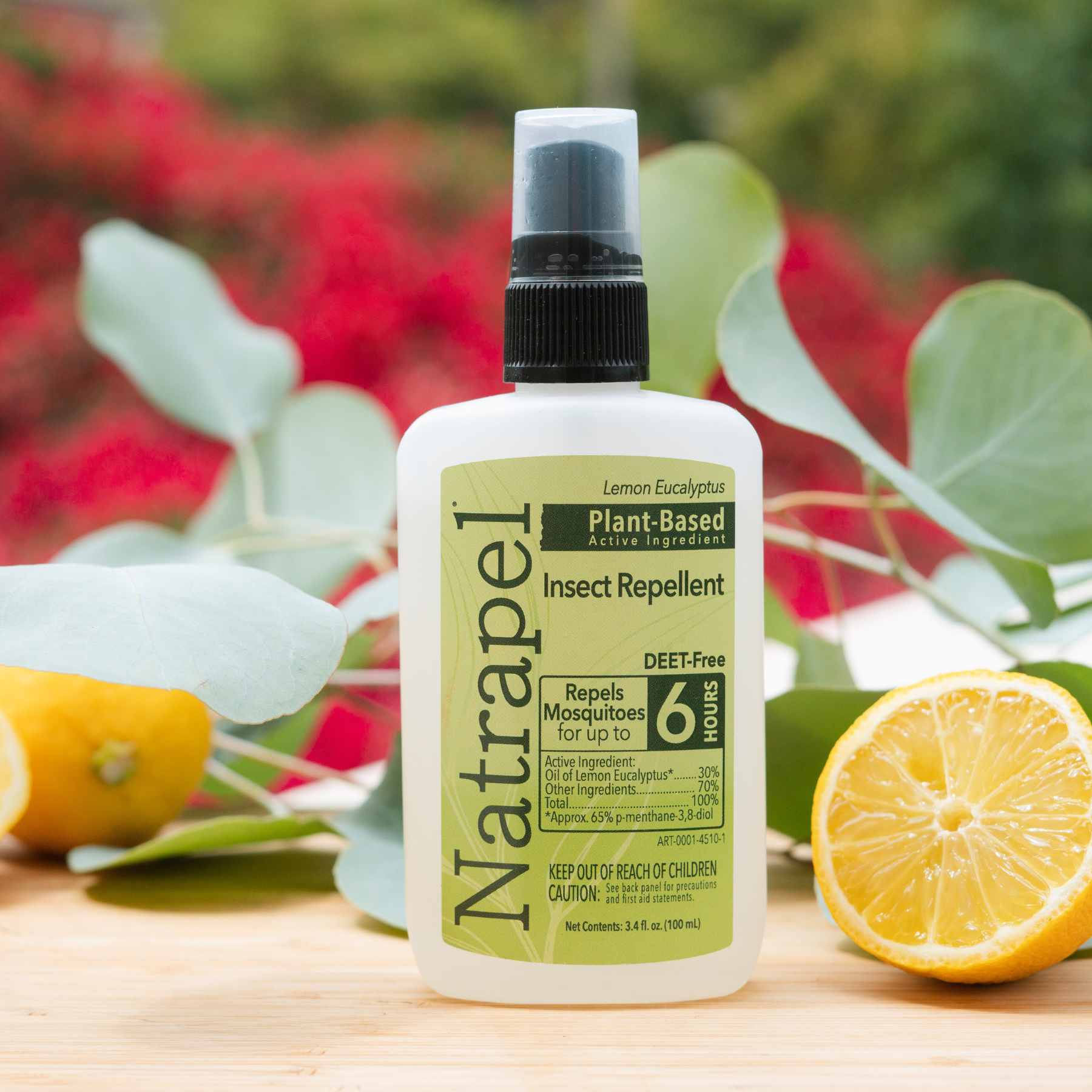 Natrapel Lemon Eucalyptus Plant Based Insect Repellent placed in front of lemons and eucalyptus leaves